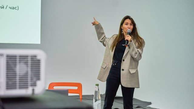 woman in front of a projector giving a presentation